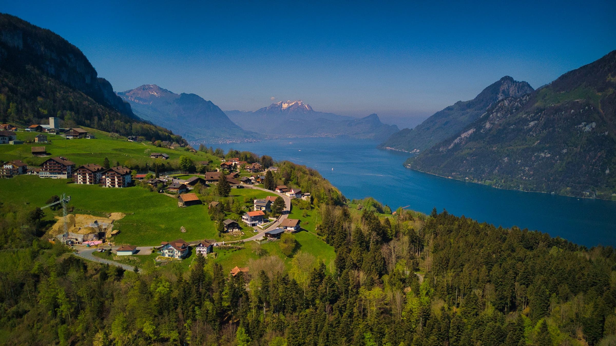 A village on green alpine slopes above Lake Lucerne, Switzerland
