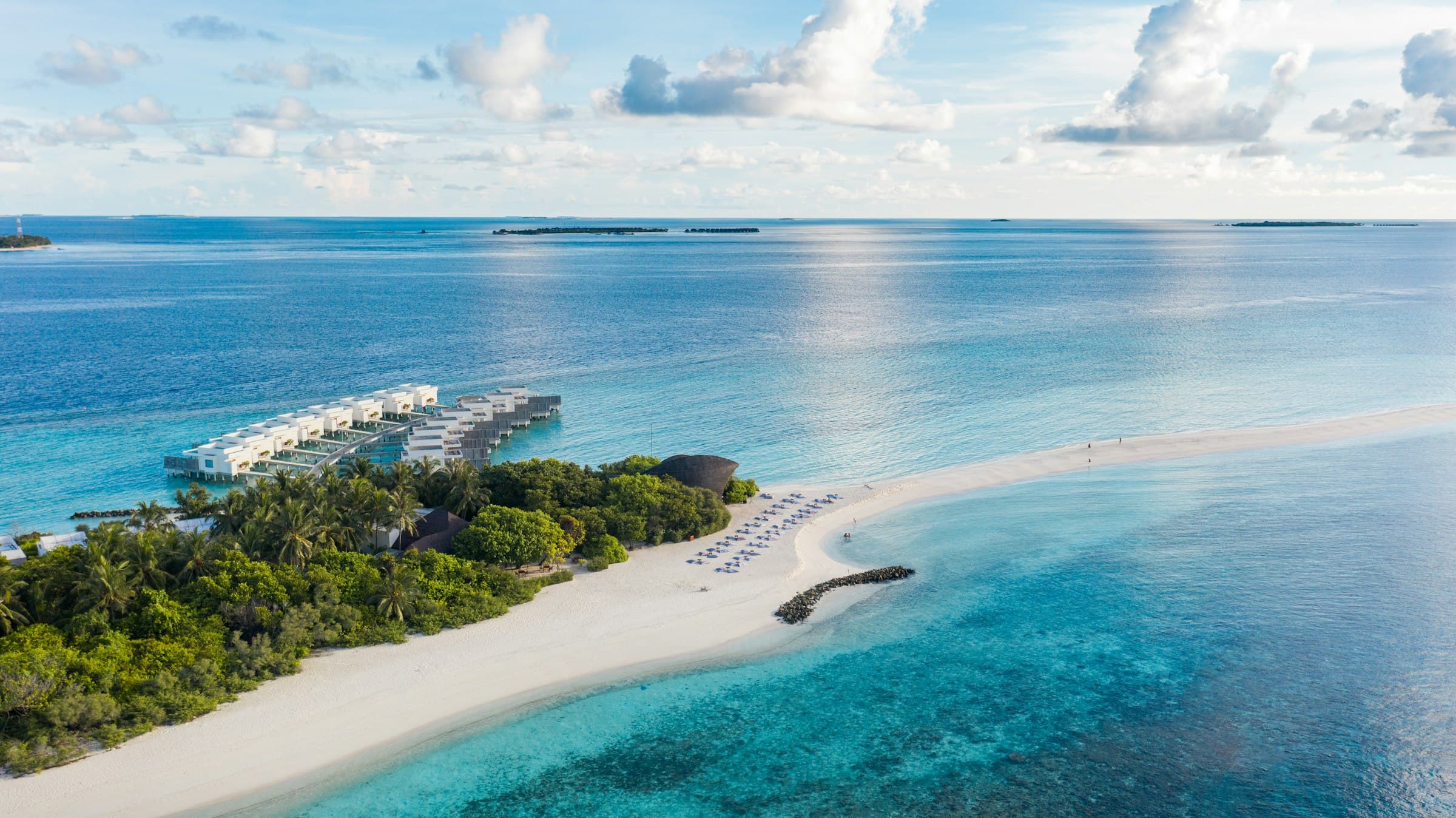 An island in the Maldives ringed by white sand and a turquoise lagoon