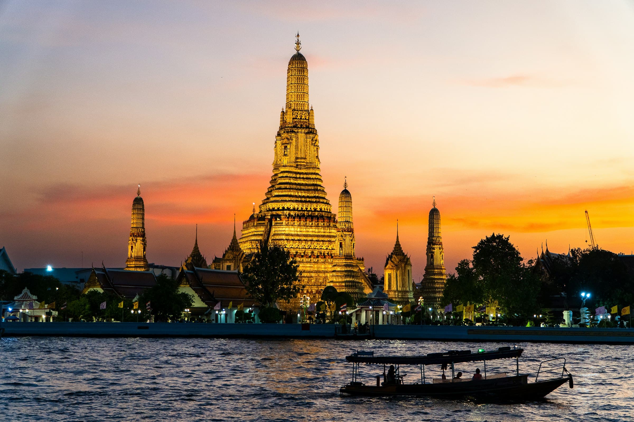Wat Arun on the Chao Phraya River in Bangkok at sunset