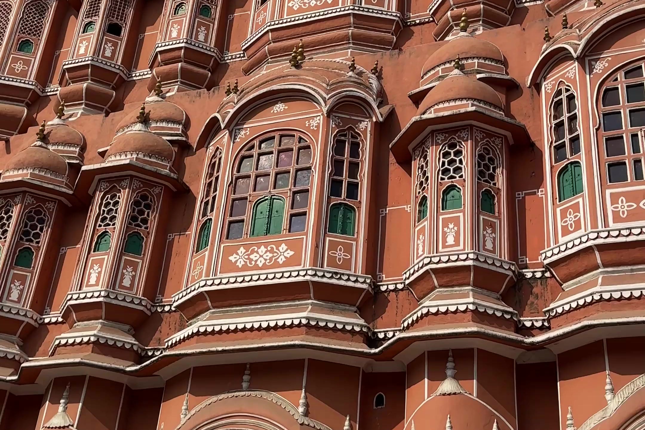 The pink sandstone windows of Hawa Mahal in Jaipur