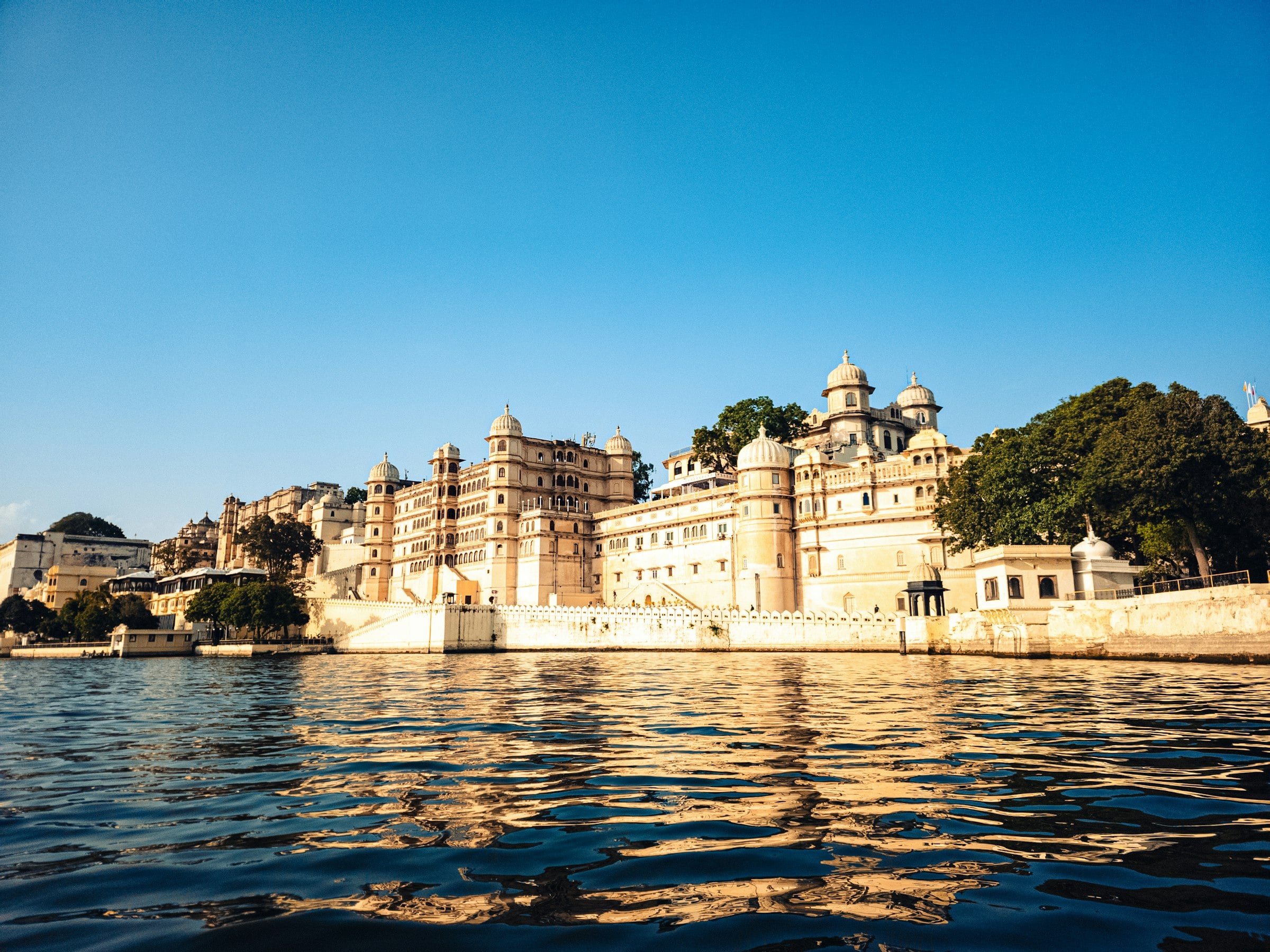 The City Palace of Udaipur in golden light above Lake Pichola