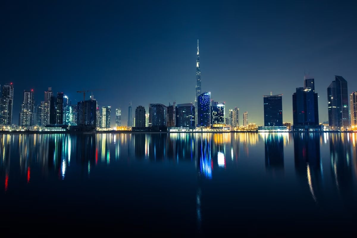 Dubai's skyline and the Burj Khalifa reflected in the water at night